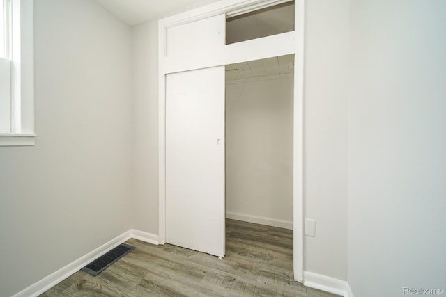 967 Keith St, Oxford, MI 48371 - unfurnished bedroom featuring wood finished floors and a closet