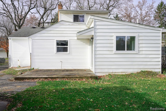 967 Keith St, Oxford, MI 48371 - back of house with a chimney
