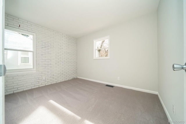 967 Keith St, Oxford, MI 48371 - carpeted empty room featuring brick wall and baseboards