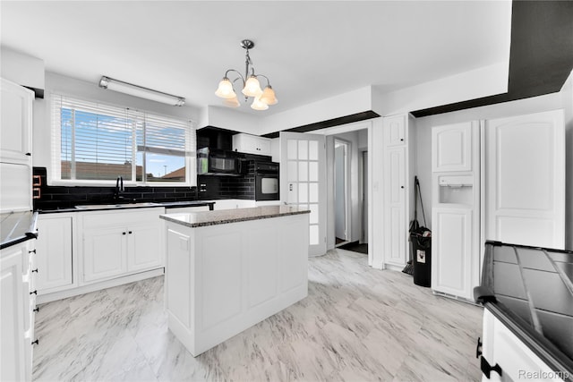 19035 Frazho Rd, Roseville, MI 48066 - kitchen with black appliances, a chandelier, tasteful backsplash, and white cabinetry
