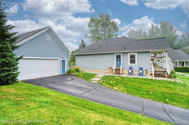 421 Montclair Ln, Howell, MI 48843 - back of house with a yard, driveway, entry steps, and a shingled roof
