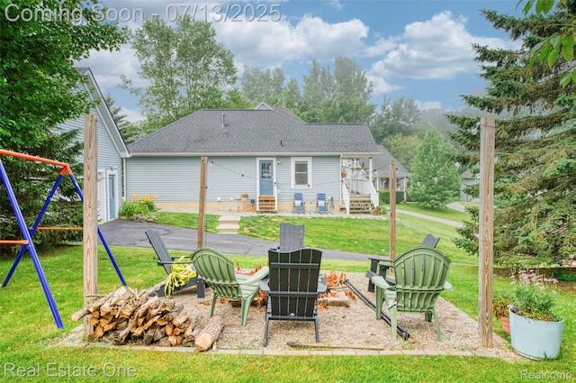 421 Montclair Ln, Howell, MI 48843 - rear view of house featuring a fire pit, a yard, and a shingled roof