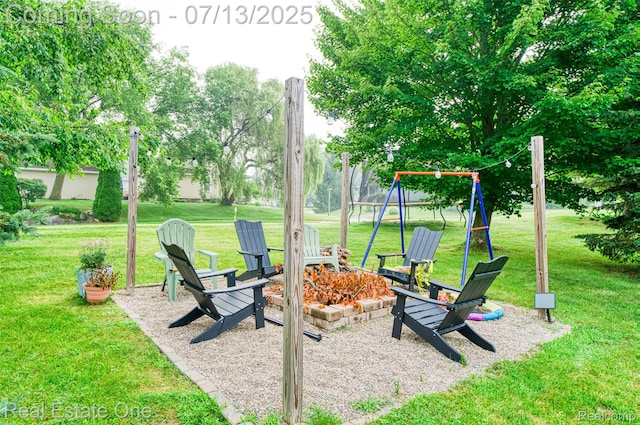 421 Montclair Ln, Howell, MI 48843 - view of grassy yard featuring an outdoor fire pit and a playground