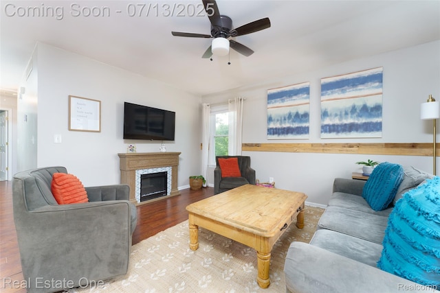 421 Montclair Ln, Howell, MI 48843 - living area featuring a ceiling fan, wood finished floors, and a fireplace