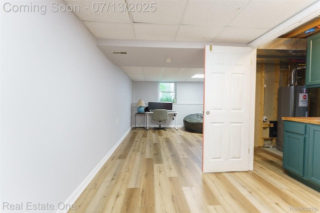 421 Montclair Ln, Howell, MI 48843 - office area with a paneled ceiling, electric water heater, and light wood-style flooring