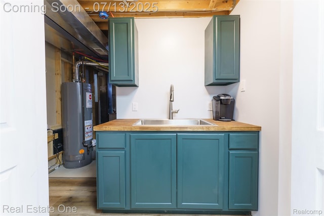 421 Montclair Ln, Howell, MI 48843 - kitchen with water heater, wood finished floors, blue cabinets, and light countertops