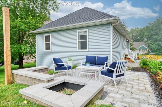 421 Montclair Ln, Howell, MI 48843 - rear view of house featuring a patio area, a shingled roof, and an outdoor living space with a fire pit