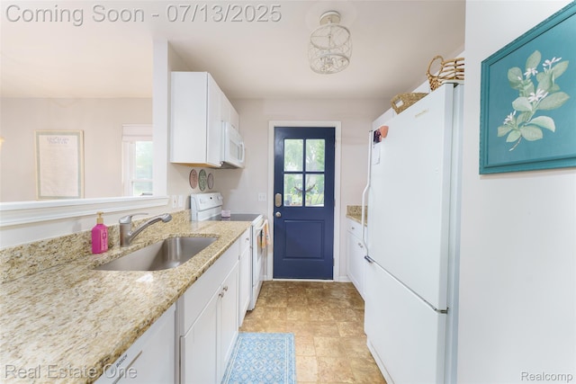 421 Montclair Ln, Howell, MI 48843 - kitchen featuring white appliances, white cabinets, and light stone countertops
