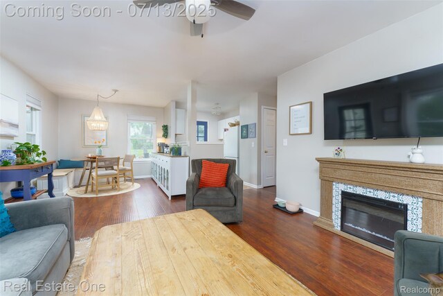 421 Montclair Ln, Howell, MI 48843 - living area featuring a ceiling fan, dark wood-type flooring, and a glass covered fireplace