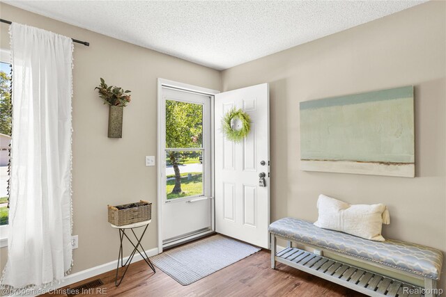 61374 Dean Dr, South Lyon, MI 48178 - entrance foyer with wood finished floors and a textured ceiling