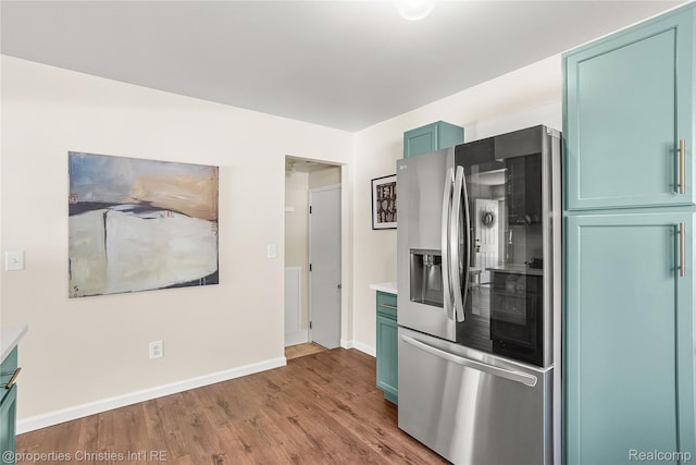 61374 Dean Dr, South Lyon, MI 48178 - kitchen featuring stainless steel refrigerator with ice dispenser, wood finished floors, and light countertops