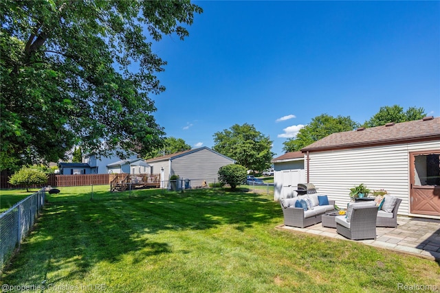 61374 Dean Dr, South Lyon, MI 48178 - fenced backyard with an outdoor hangout area and a patio area