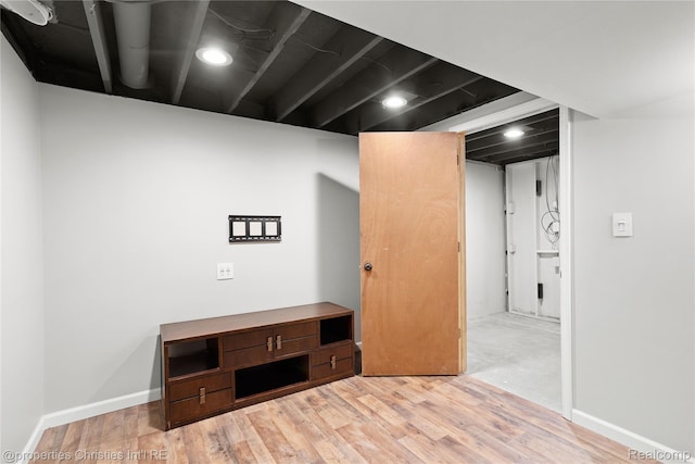 61374 Dean Dr, South Lyon, MI 48178 - finished below grade area featuring light wood-type flooring and baseboards