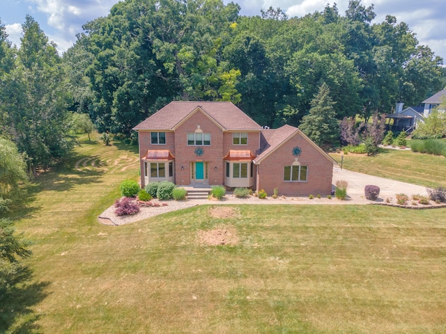 7184 Steeplechase Dr, Saline, MI 48176 - colonial home featuring brick siding and a front yard