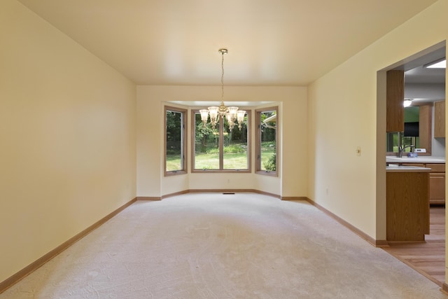 7184 Steeplechase Dr, Saline, MI 48176 - unfurnished dining area featuring a chandelier and light carpet