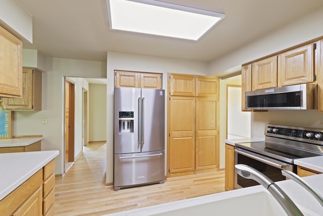 7184 Steeplechase Dr, Saline, MI 48176 - kitchen with appliances with stainless steel finishes, light wood-type flooring, light countertops, and light brown cabinets