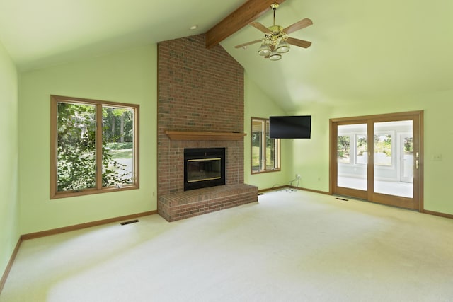 7184 Steeplechase Dr, Saline, MI 48176 - unfurnished living room featuring plenty of natural light, carpet flooring, and a brick fireplace