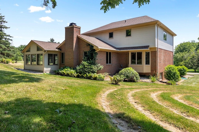 7184 Steeplechase Dr, Saline, MI 48176 - rear view of house with brick siding, a lawn, a chimney, and roof with shingles