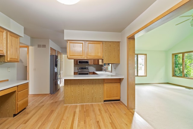 7184 Steeplechase Dr, Saline, MI 48176 - kitchen featuring stainless steel appliances, light countertops, light wood-style flooring, and a peninsula
