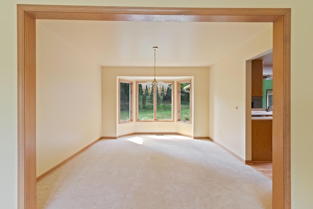 7184 Steeplechase Dr, Saline, MI 48176 - unfurnished room with a chandelier and light colored carpet