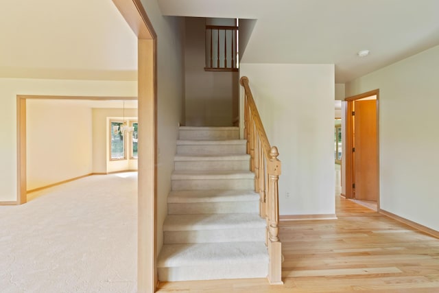 7184 Steeplechase Dr, Saline, MI 48176 - stairway featuring baseboards and wood finished floors