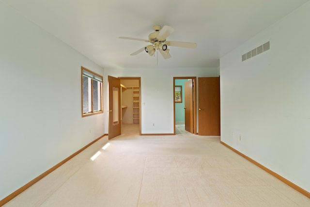 7184 Steeplechase Dr, Saline, MI 48176 - unfurnished bedroom featuring a spacious closet, a closet, light carpet, and a ceiling fan