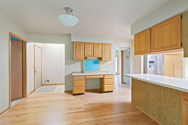 7184 Steeplechase Dr, Saline, MI 48176 - kitchen featuring high quality fridge, light wood-type flooring, light countertops, and a desk