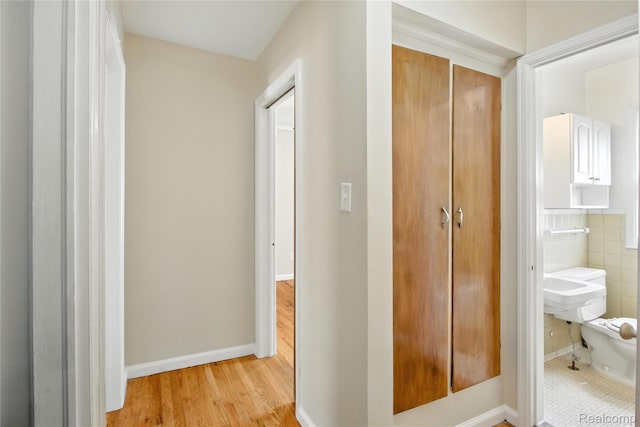 14888 Belmont Ave, Southgate, MI 48101 - hallway featuring wood finished floors and tile walls