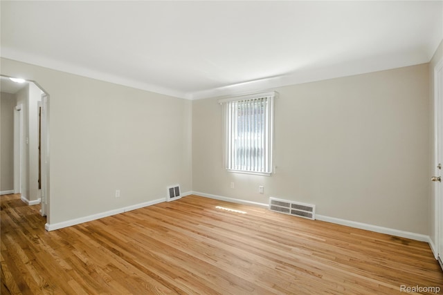 14888 Belmont Ave, Southgate, MI 48101 - spare room featuring light wood-style flooring and arched walkways