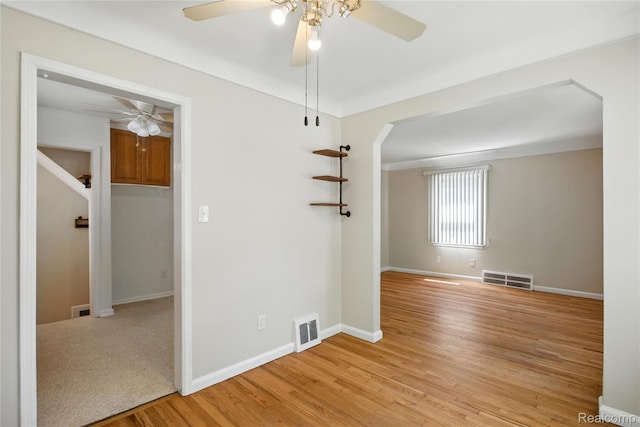 14888 Belmont Ave, Southgate, MI 48101 - empty room with ceiling fan, light wood finished floors, and arched walkways
