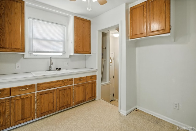 14888 Belmont Ave, Southgate, MI 48101 - kitchen with brown cabinetry, light countertops, a ceiling fan, and light carpet