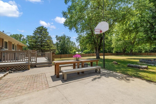 9950 Carpenter Rd, Milan, MI 48160 - fenced backyard with a wooden deck, a patio, and view of wooded area