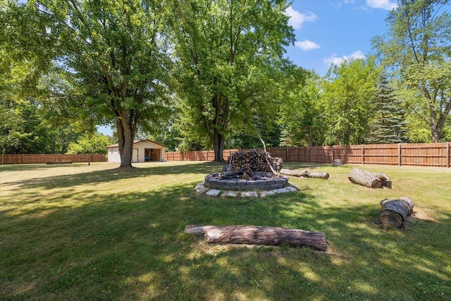9950 Carpenter Rd, Milan, MI 48160 - fenced backyard with a fire pit