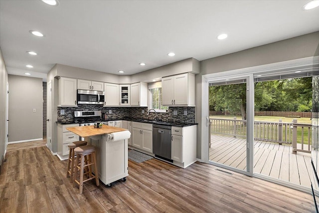 9950 Carpenter Rd, Milan, MI 48160 - kitchen with appliances with stainless steel finishes, butcher block counters, backsplash, dark wood-style flooring, and recessed lighting