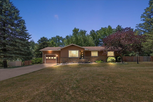 9950 Carpenter Rd, Milan, MI 48160 - view of front of property featuring a garage, concrete driveway, and stone siding