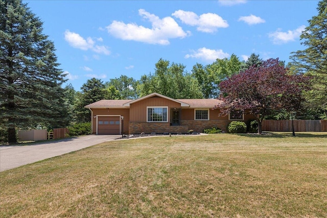 9950 Carpenter Rd, Milan, MI 48160 - ranch-style home with an attached garage, driveway, and stone siding