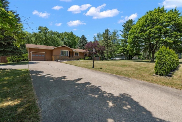 9950 Carpenter Rd, Milan, MI 48160 - ranch-style house with an attached garage, stone siding, a front lawn, and concrete driveway