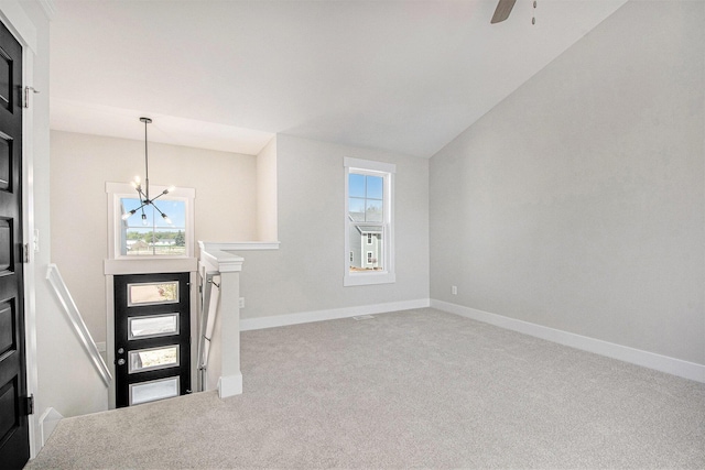7457 Traditional Ct, Caledonia, MI 49316 - foyer entrance with carpet, a chandelier, plenty of natural light, ceiling fan, and vaulted ceiling