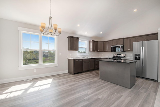7457 Traditional Ct, Caledonia, MI 49316 - kitchen with appliances with stainless steel finishes, a chandelier, light wood-style floors, recessed lighting, and high vaulted ceiling