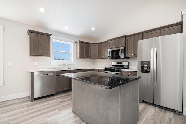 7457 Traditional Ct, Caledonia, MI 49316 - kitchen with stainless steel appliances, dark brown cabinetry, dark stone counters, light wood-type flooring, and recessed lighting