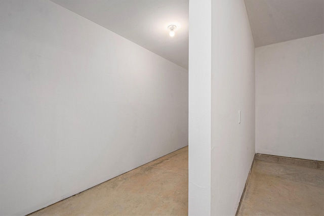 7457 Traditional Ct, Caledonia, MI 49316 - additional living space featuring unfinished concrete flooring and vaulted ceiling