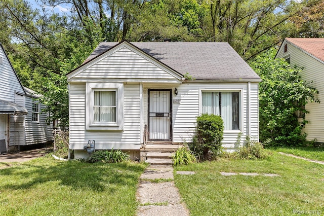 16934 Pembroke Ave, Detroit, MI 48235 - view of front of property featuring a front lawn and a shingled roof