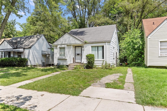 16934 Pembroke Ave, Detroit, MI 48235 - view of front facade with a front yard and roof with shingles