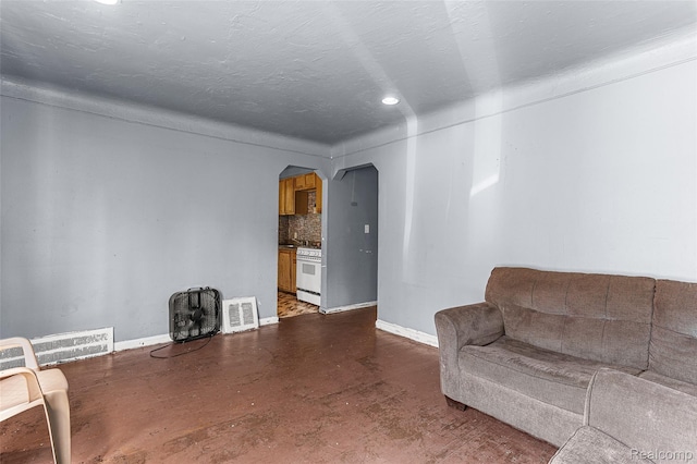 16934 Pembroke Ave, Detroit, MI 48235 - living area with arched walkways, finished concrete floors, and recessed lighting