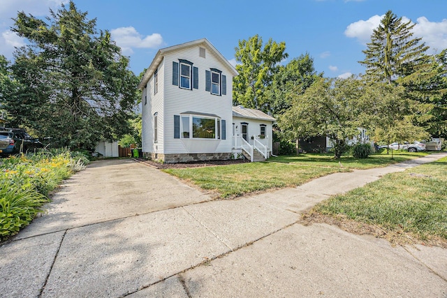 416 Kent St, Lowell, MI 49331 - traditional-style house with concrete driveway and a front yard