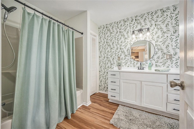 416 Kent St, Lowell, MI 49331 - bathroom with wallpapered walls, shower / tub combo, vanity, and wood finished floors