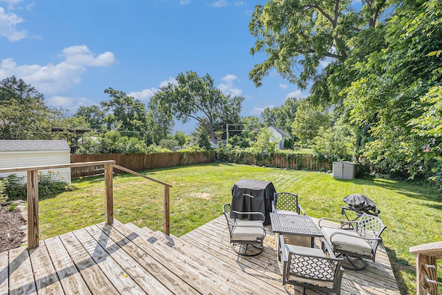 416 Kent St, Lowell, MI 49331 - wooden terrace featuring area for grilling, a fenced backyard, and a storage shed