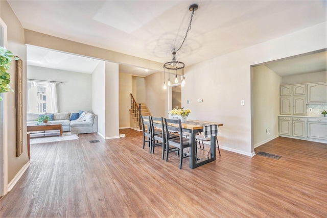 416 Kent St, Lowell, MI 49331 - dining area featuring light wood-style floors and stairway