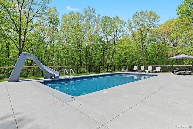 4286 Center Rd, Linden, MI 48451 - view of swimming pool featuring a water slide and a patio area