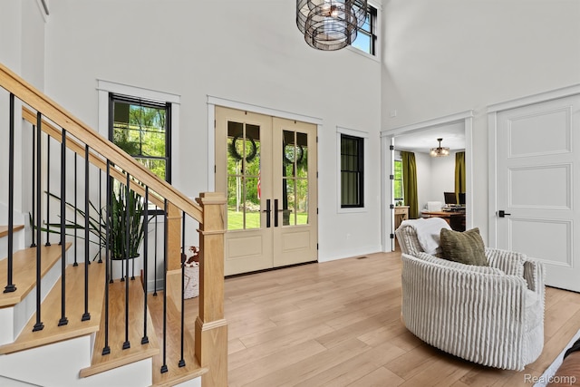 4286 Center Rd, Linden, MI 48451 - entryway with stairs, a high ceiling, wood finished floors, and french doors
